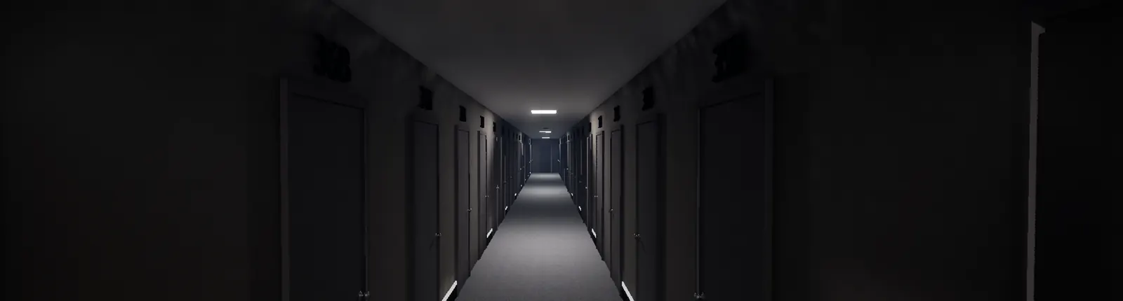 An empty, dim facility corridor lined with identical closed doors